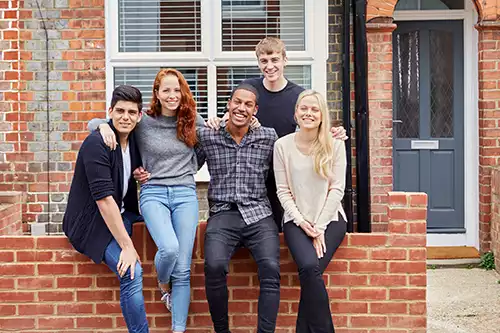 happy students outside student housing